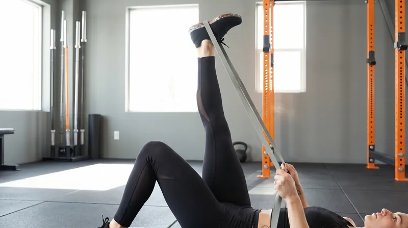 Using resistance bands during stretching builds strength at end-ranges, signaling safety to the nervous system.