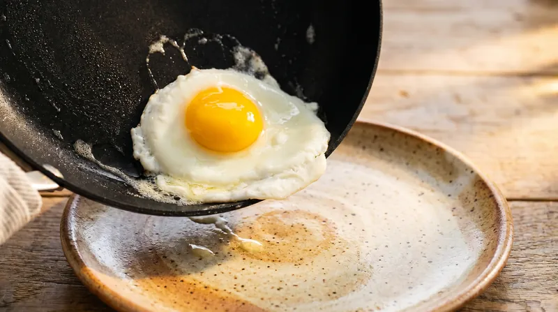 Both PTFE and ceramic pans excel at releasing delicate foods like eggs when brand new.
