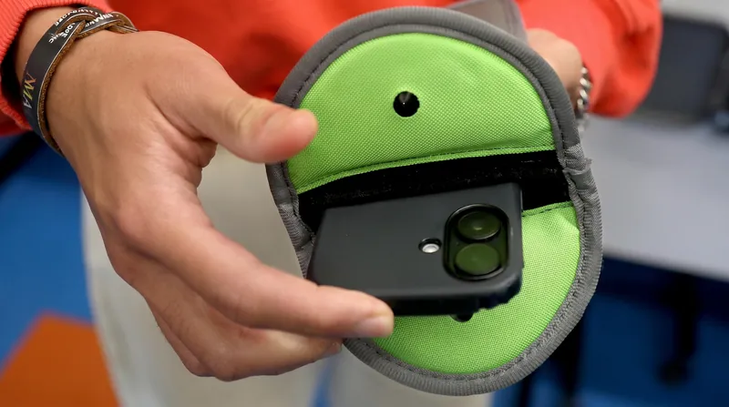 Many districts rely on physical hardware, such as magnetic locking pouches, to enforce bell-to-bell bans without confiscating devices.