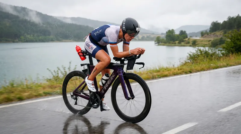 Athletes battled shifting winds and wet roads during the 180-kilometer bike leg.