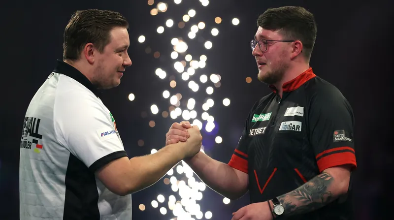 Humphries and Littler embrace following their grueling 21-leg final.