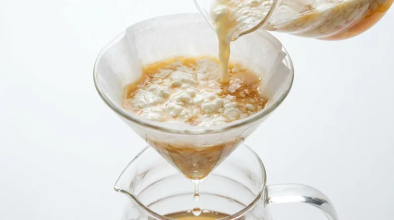 As the mixture is strained, the curds form a natural filter bed that traps tannins and pigments.