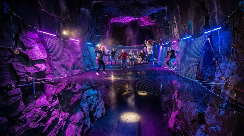 Bounce Below in Wales features giant trampoline nets suspended inside a Victorian-era slate cavern.