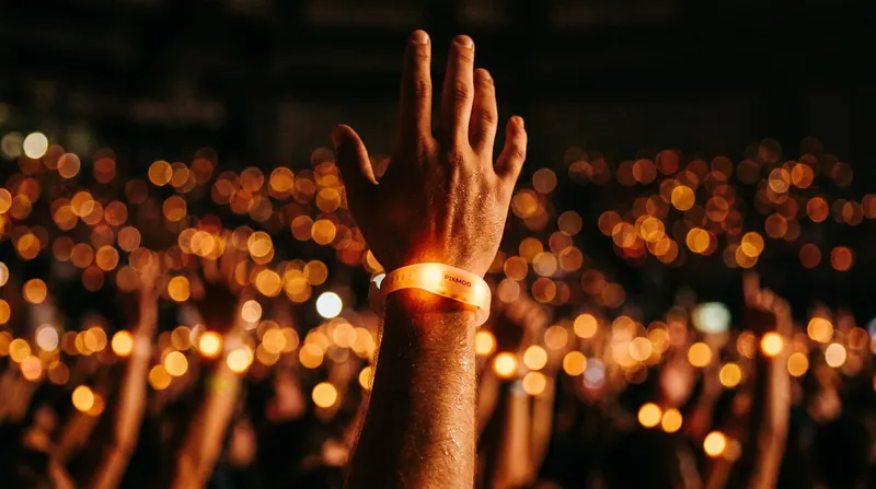 Infrared wristbands act as individual pixels, reacting to invisible light beams projected across the arena.