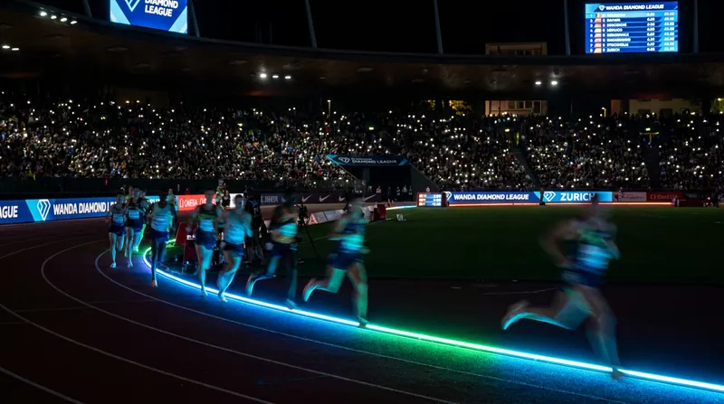 The lights provide an instant visual reference for spectators tracking world-record pace.