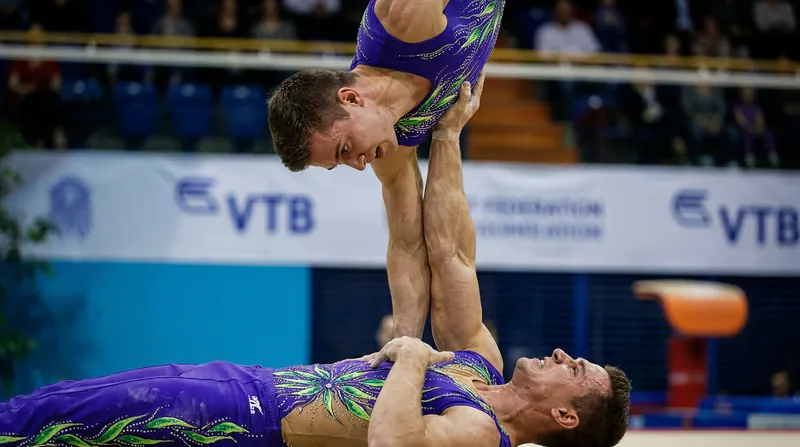 Acrobatic gymnastics relies entirely on human biomechanics and extreme trust between partners.