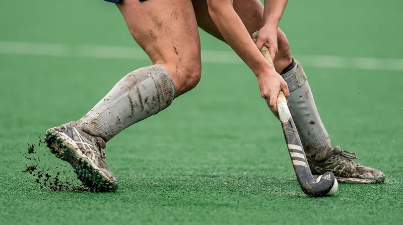 The unique crouched posture of field hockey places immense biomechanical stress on the knees and ankles.