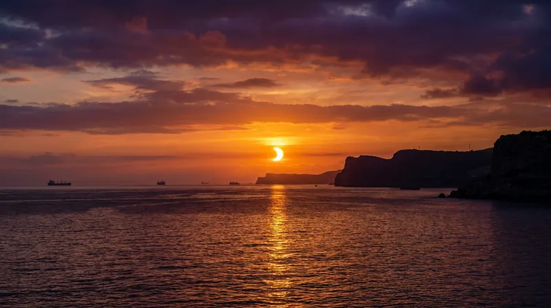 Observers in Spain and the Balearic Islands will witness a rare low-horizon 'sunset eclipse.'