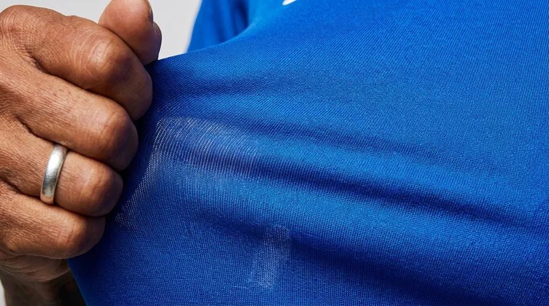 The introduction of elastane blends in the early 2000s allowed shirts to stretch up to 30 centimeters, exposing defensive fouls.