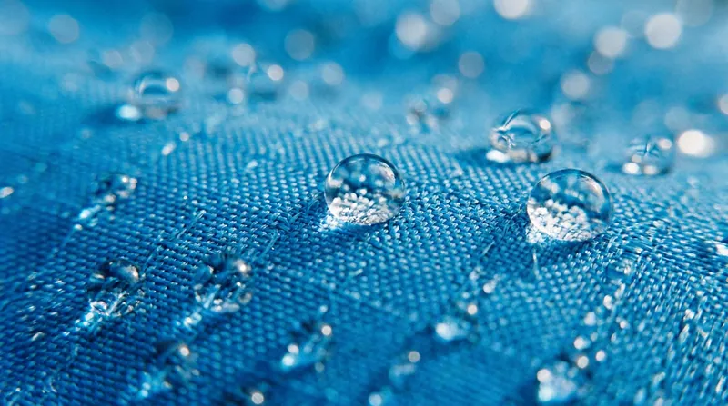New hydrocarbon and silicone-based Durable Water Repellent (DWR) coatings effectively shed water, but require more frequent washing to maintain performance.