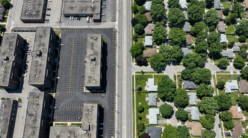 Historically redlined neighborhoods with less tree canopy can experience temperatures up to 7°C hotter than surrounding areas.