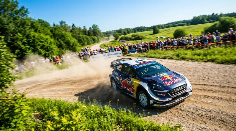 Fans watch as a Rally1 car drifts through the Estonian forests.