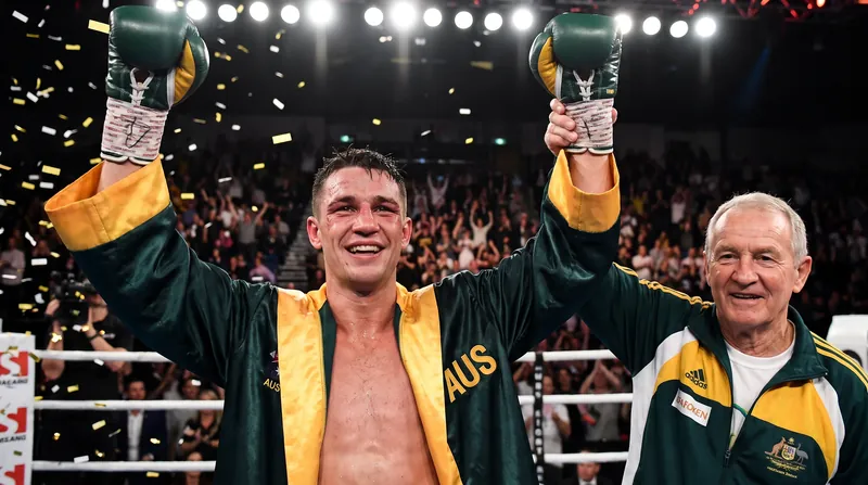 Tim Tszyu celebrates his career-resurrecting victory alongside trainer Jeff Fenech.