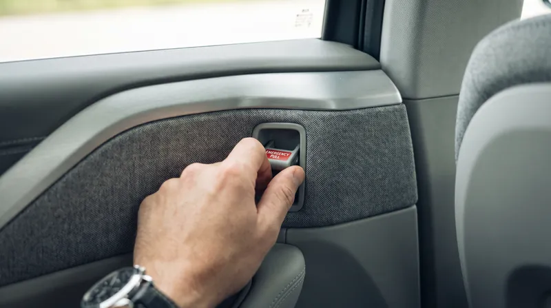 Many modern vehicles hide mechanical backup releases behind trim panels or in unintuitive locations.