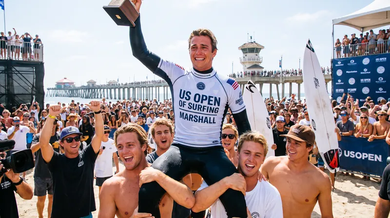 Marshall is chaired up the beach by his brothers following his maiden WSL victory.