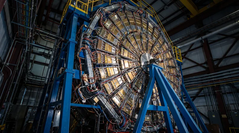 During collisions at near-light speeds, the proton's quarks continued forward while the baryon junction was stopped, separating the particle's electric charge from its baryon number.