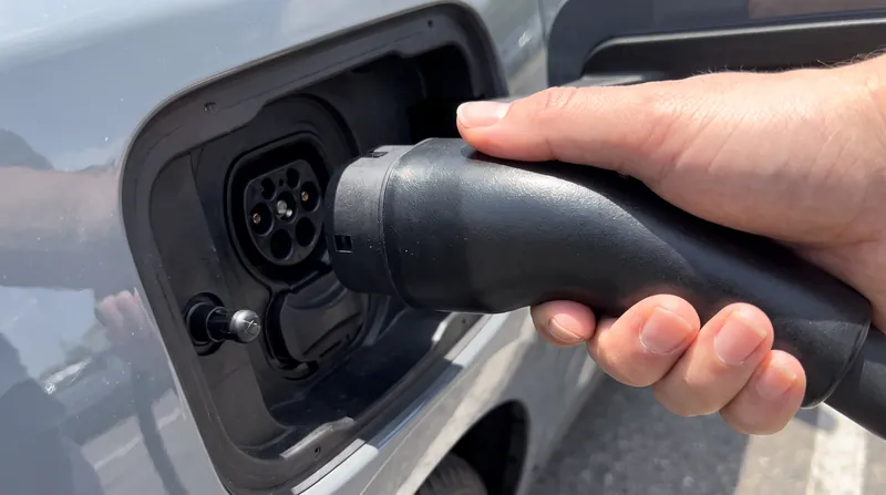 The NACS connector handles both AC and DC fast charging through a single, compact 5-pin interface.