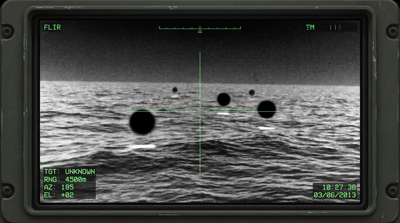 The released footage consists of cell phone recordings of the gunship's infrared displays, showing the objects as dark, cold spheres.