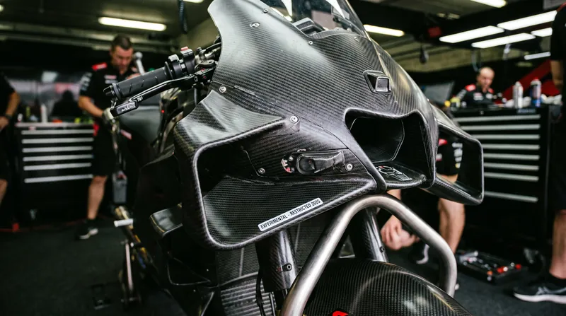 Complex aerodynamic appendages will face strict new width limits and development freezes to control costs.