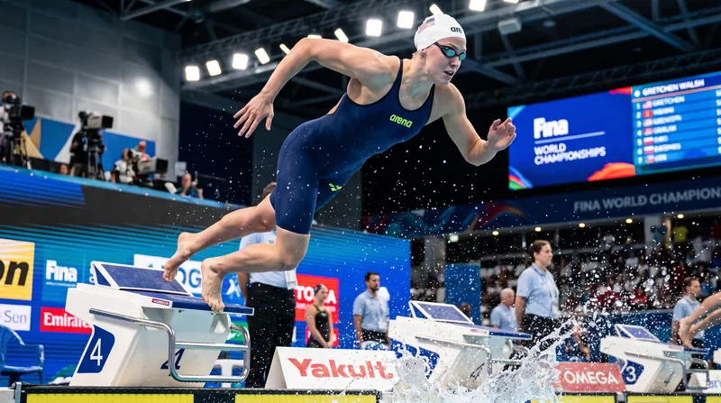 Gretchen Walsh used her signature front-end speed to lead at the 50-meter turn before Harris closed the gap.