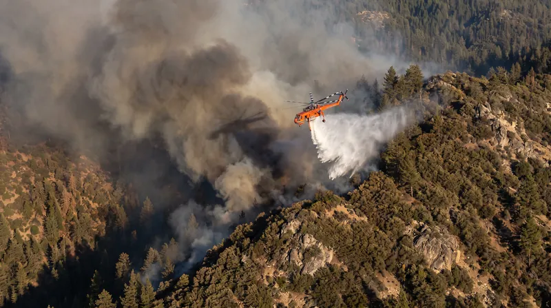 Steep topography has limited the use of heavy machinery, forcing fire command to rely heavily on aerial water drops.