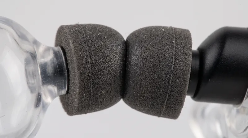 Dense materials like memory foam provide passive isolation by physically blocking high-frequency sound waves.