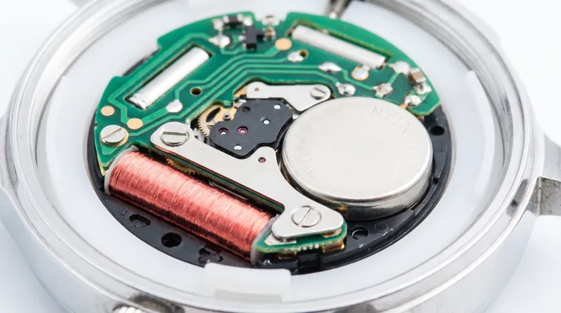 A quartz movement replaces complex gear trains with a battery, a microchip, and a vibrating quartz crystal.