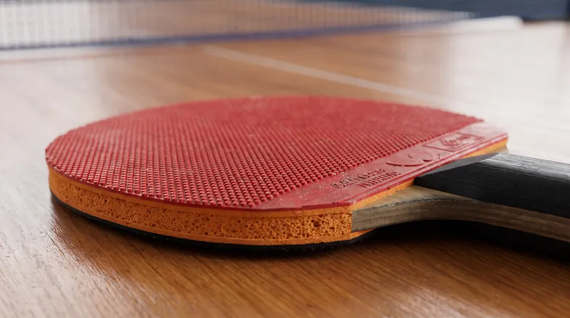 Modern sponge-backed, tacky rubber is essential for gripping the ball and transferring kinetic energy into extreme rotational speed.