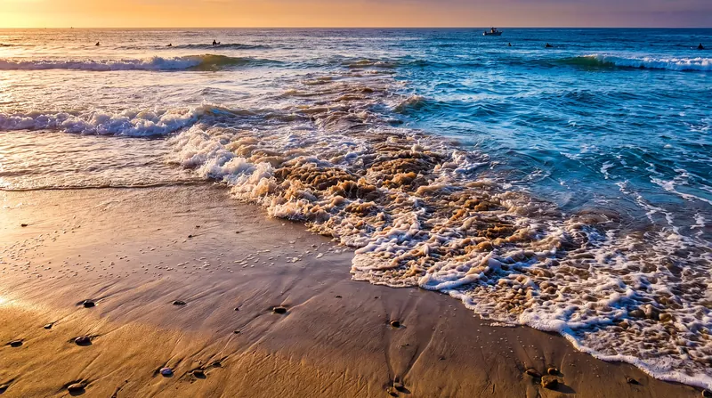 Churning, discolored water or a steady line of sea foam moving seaward are key visual indicators of a rip current.