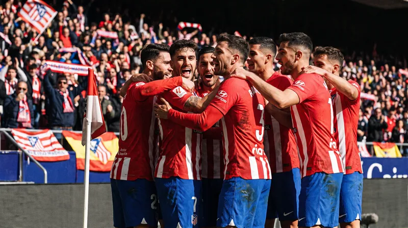Atlético Madrid players celebrate taking the provisional lead in the La Liga standings.