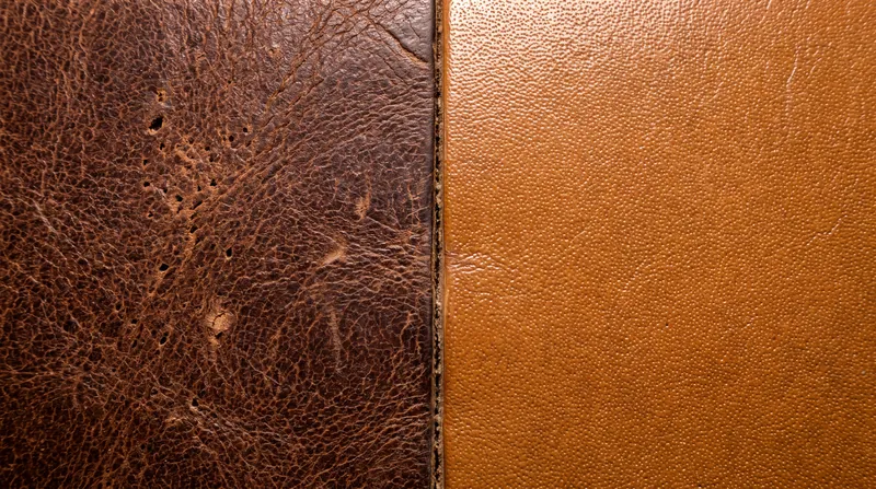Full-grain leather retains natural pores and imperfections, while top-grain is sanded for a uniform finish.