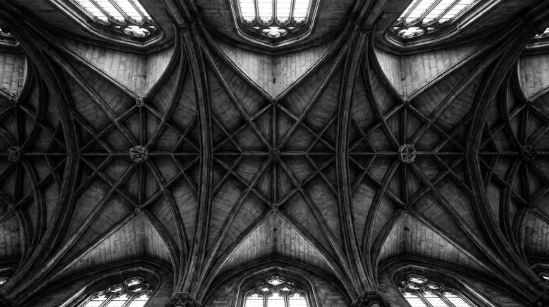 Ribbed vaults act as a load-bearing skeleton, allowing the ceiling webbing to be remarkably thin.