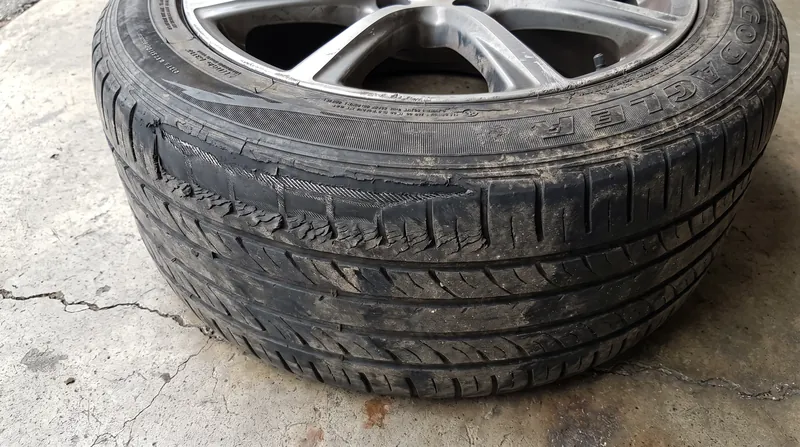 Feathered tread wear is a primary indicator that a vehicle's toe angle is out of specification.