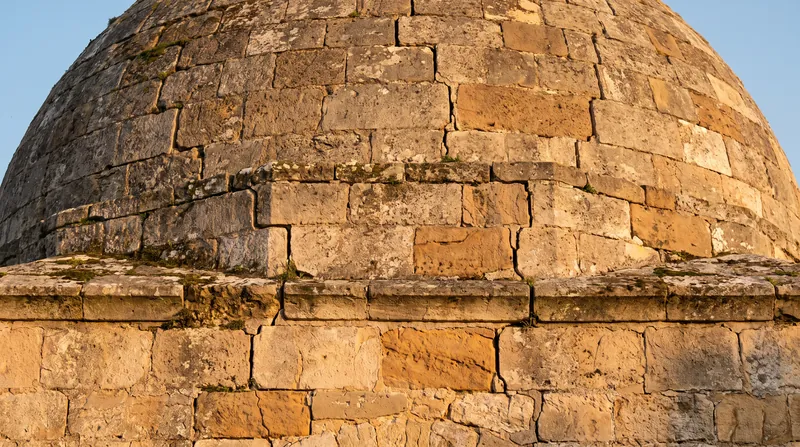 Meridional cracks at the base of a dome relieve hoop tension, allowing the structure to act as a series of independent arches.