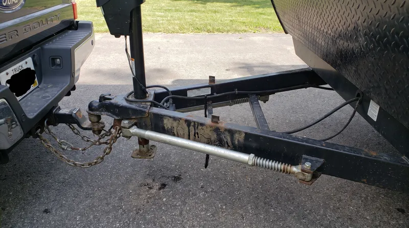 Weight distribution hitches use spring bars to leverage the connection, pushing weight forward to the tow vehicle's front axle to restore steering control.