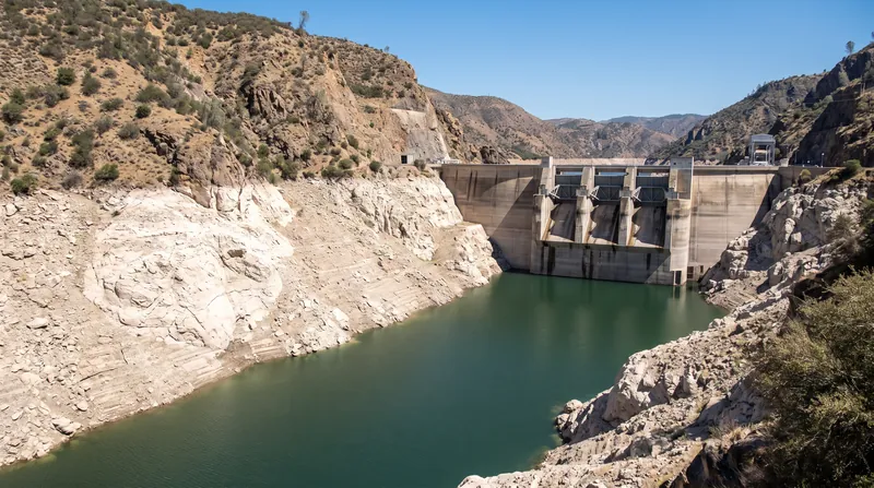 Drought conditions exponentially reduce power output by simultaneously lowering both hydraulic head and available flow rate.