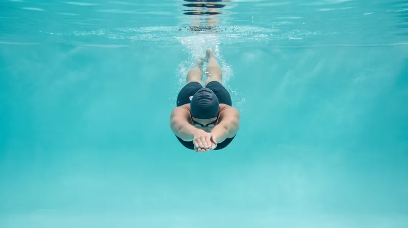 Minimizing frontal surface area is critical, as active drag compounds exponentially with every degree the hips or legs drop.