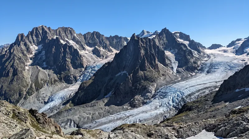A wide view of the steep, rocky, and glaciated peaks of the Mont Blanc massif.