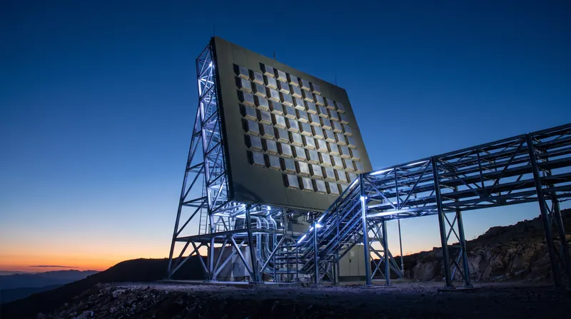 A large, flat-faced phased array radar installation pointing toward a clear sky.