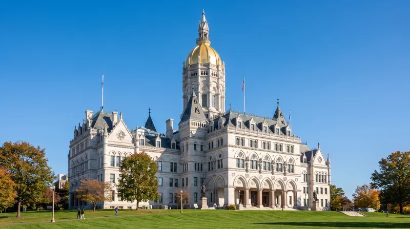 The Connecticut State Capitol building in Hartford featuring its distinctive gold dome under a clear sky.