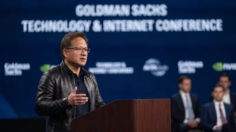 Nvidia CEO Jensen Huang speaking at a podium during a financial conference, wearing his signature black leather jacket.