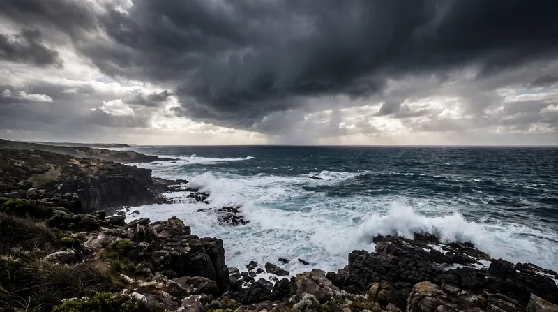 A dark, powerful storm front gathering over the deep blue waters of the Indian Ocean.