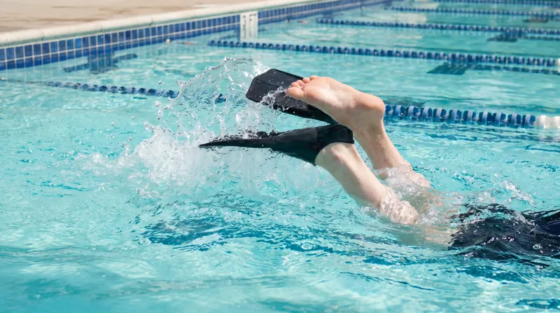 A tight, 12-inch kick with relaxed ankles provides optimal lift without creating excess drag.