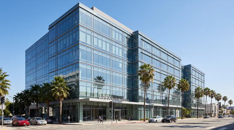 Exterior view of a modern glass office building housing a major Hollywood talent agency in Los Angeles.