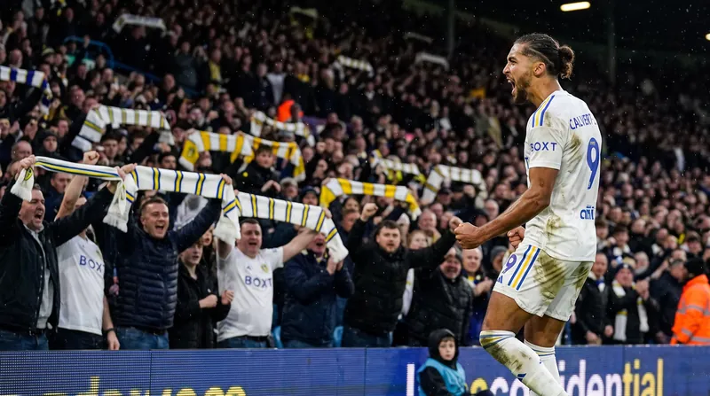 Dominic Calvert-Lewin celebrating a goal for Leeds United in a packed Elland Road stadium.
