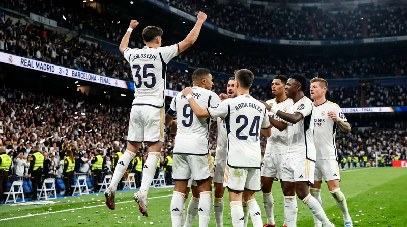 Real Madrid players including Carlos Espí and Kylian Mbappé celebrating a goal on the pitch at night.