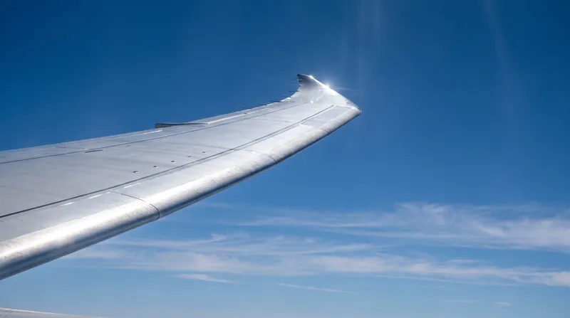 The aerodynamic forces keeping an aircraft aloft rely on deflecting massive volumes of air downward.