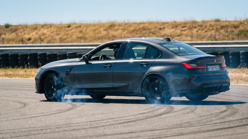A modern sedan braking aggressively on a test track with slight smoke coming from the tires.