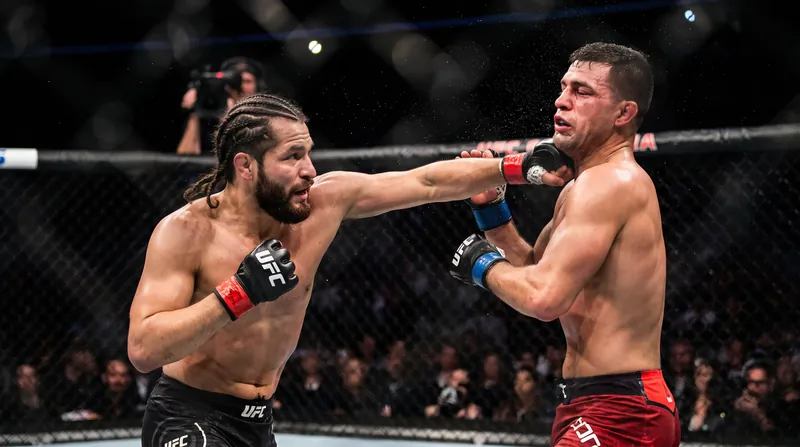 A mixed martial arts fighter landing a lateral hook punch on an opponent's jaw.