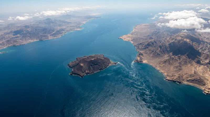 Aerial view of the Bab el-Mandeb Strait showing Perim Island dividing the waterway between the coasts of Yemen and Djibouti.